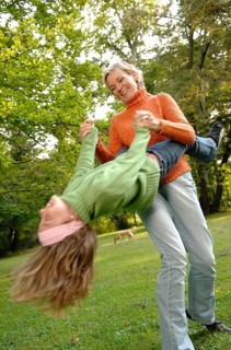 Mother and daughter run around in the park