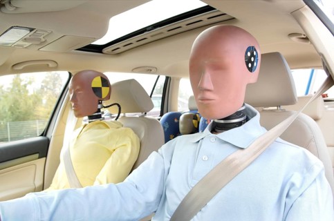 Family of crash test dummies in a car