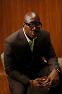 Bald man in a suit with glasses