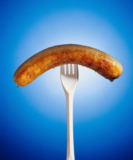 Grilled sausage on a plastic fork