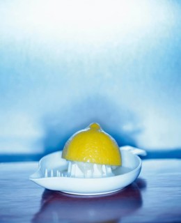 Squeezed lemon in a lemon squeezer