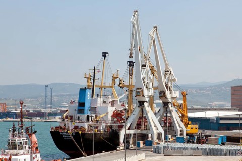Cargo ship being unloaded in the port of Koper