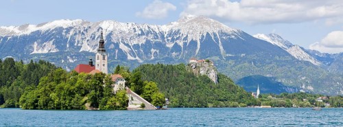Blejski Otok Island with St. Mary's Church in Lake Bled and The Karawanks mountain range in Bled