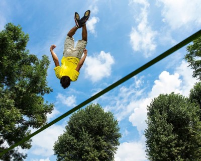 Young man jumping on a slackline