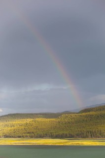 Heavy clouds and rainbow over Marsh Lake