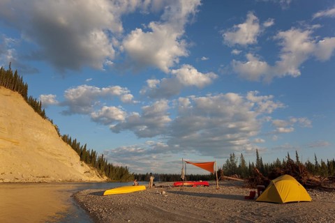 camp with tent and tarp on a gravel bar