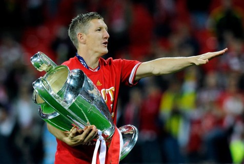 Bastian Schweinsteiger holding the trophy