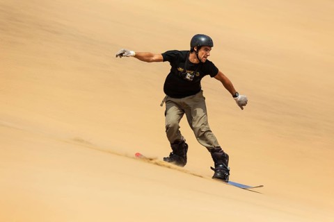 Man surfing the dunes