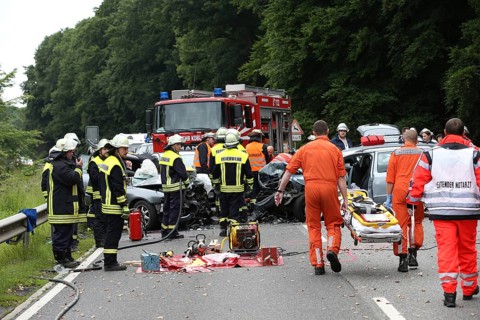Rescue workers from the fire brigade and the German Red Cross in action at a traffic accident on federal road 327