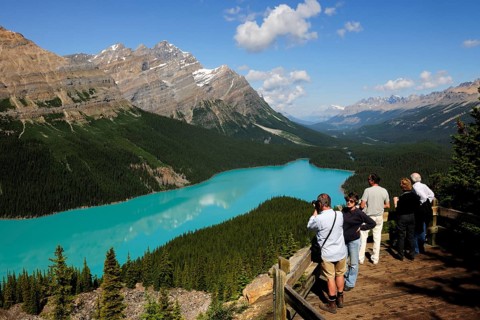 Observation platform with tourists admiring Peyto Lake in the Rocky Mountains