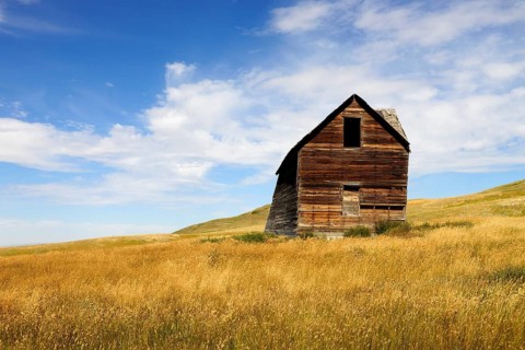 Abandoned and decaying house on the prairie