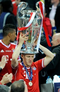 Bastian Schweinsteiger holding the trophy