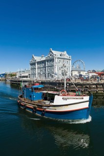Fishing cutter in front of the African Trading Port building