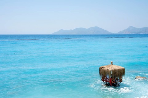 Waterfront hut on the beach in the turquoise water of Lykia World Village Hotel Resort