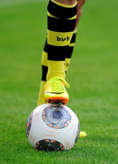 Legs of a BVB player with an Adidas Torfabrik league ball
