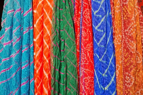 Colourful silk scarves are displayed for sale