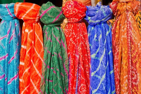 Colourful silk scarves are displayed for sale
