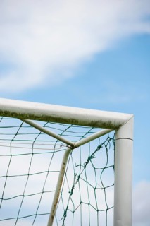 Blue sky and detail of football goal