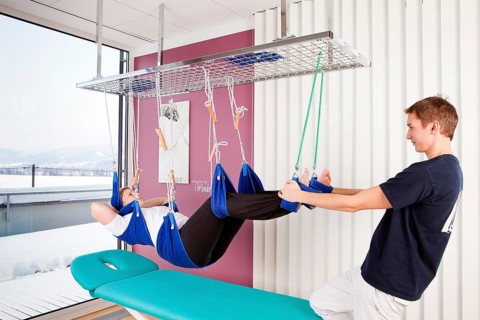 Patient and physiotherapist during sling table therapy