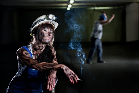 Female mine worker holding a cigarette