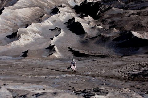 Man bringing a sacrificial offering to Mount Bromo volcano