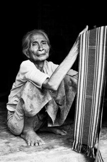 Elderly Indonesian woman selling fabrics