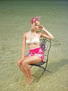 Woman sitting on a chair in the water