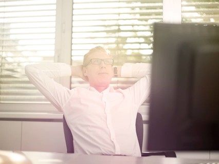 Man sitting in front of his computer in an office