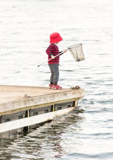 Child standing on jetty