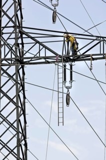 High voltage technician installing a new high-voltage power line