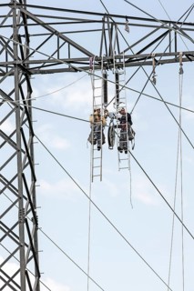 High-voltage service technicians installing a new high voltage power line