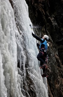 Ice climber climbing a frozen waterfall