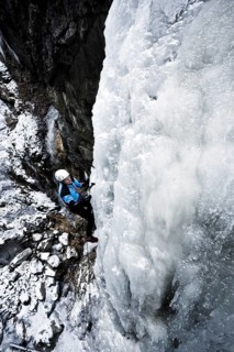 Ice climber climbing a frozen waterfall