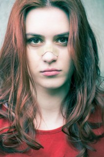Portrait of a young woman with a band-aid on her nose