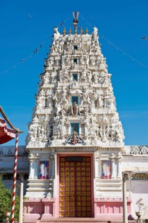 Depiction of gods and figures in white marble on a shikhara tower of a Hindu temple