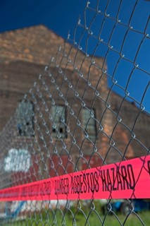 A warning of an asbestos hazard at the old Globe Trading Company building