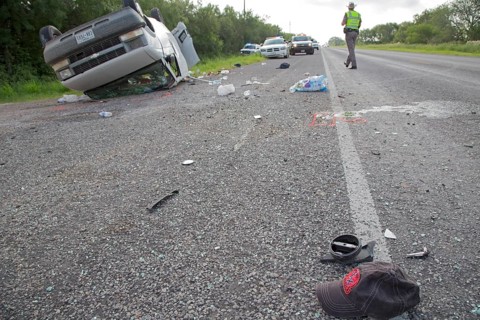 A baseball cap lying on the road after a van holding 26 undocumented immigrants from Central America overturned on Texas Highway 285
