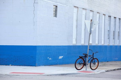 A bicycle parked on a street corner