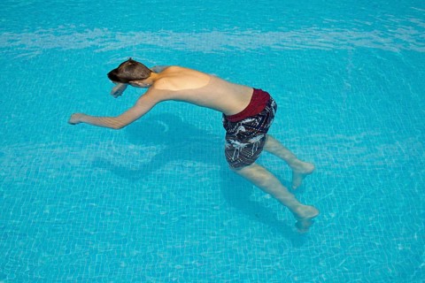 Motionless boy in a swimming pool