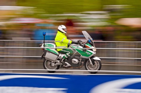Accompanying motorcycle of the Rund um Koeln cycling race during rainy weather