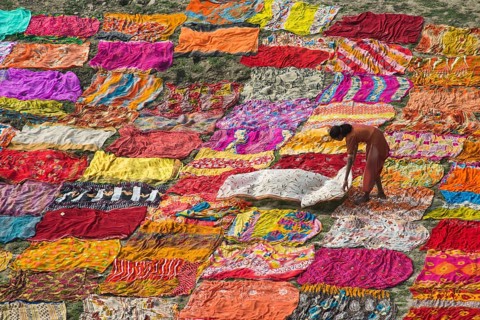 Colourful saris spread out to dry