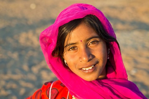 Smiling young woman with a headscarf and a bindi on her forehead