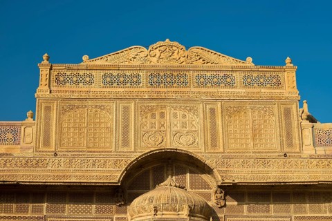 Richly decorated sandstone facade of an old Haveli or private mansion