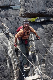 Tourist crossing a suspension bridge in the Great Tsingy de Bemaraha limestone formations