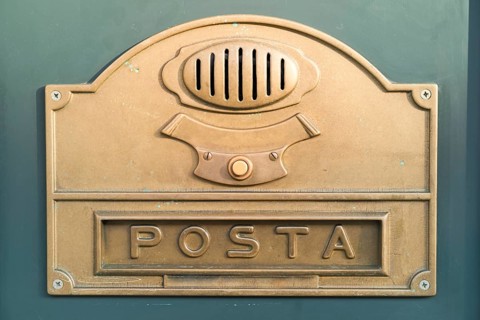 Brass plate with a doorbell button and a letter box