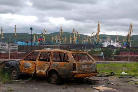Scrap car next to a railroad