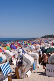 Roofed wicker beach chairs on a beach