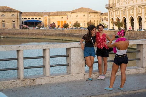 Women posing on the bridge crossing the Nevole River during the Summer Jamboree Rock'n'Roll Festival