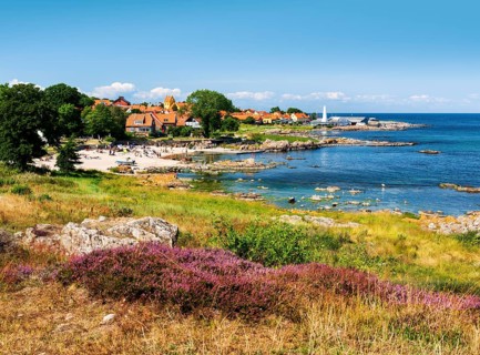 View of Allinge with bathing area and smokehouse on the rocky coast of the Baltic Sea