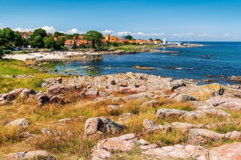 View of Allinge with bathing area and smokehouse on the rocky coast of the Baltic Sea